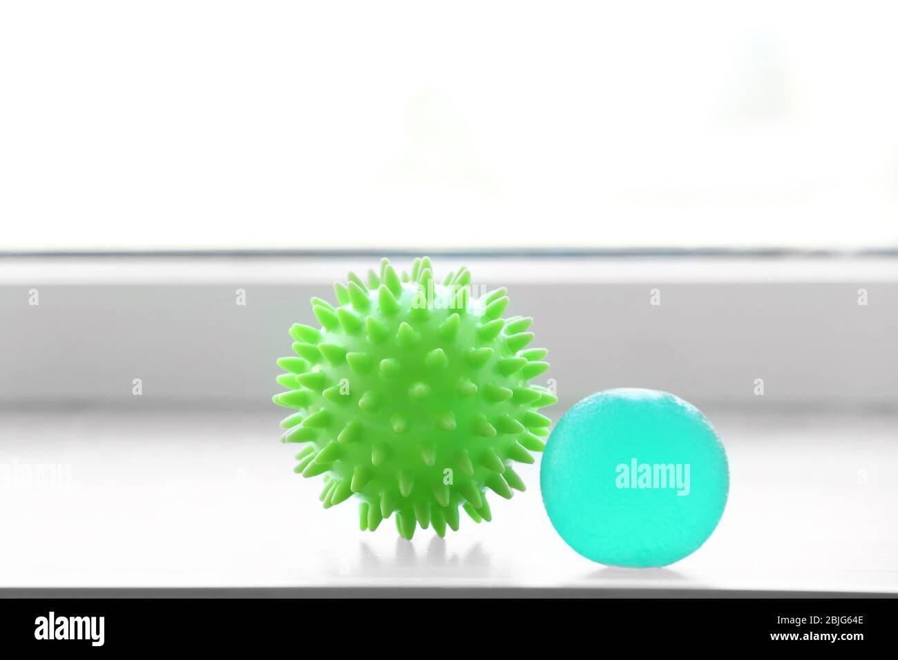 Two rubber balls on window sill Stock Photo Alamy