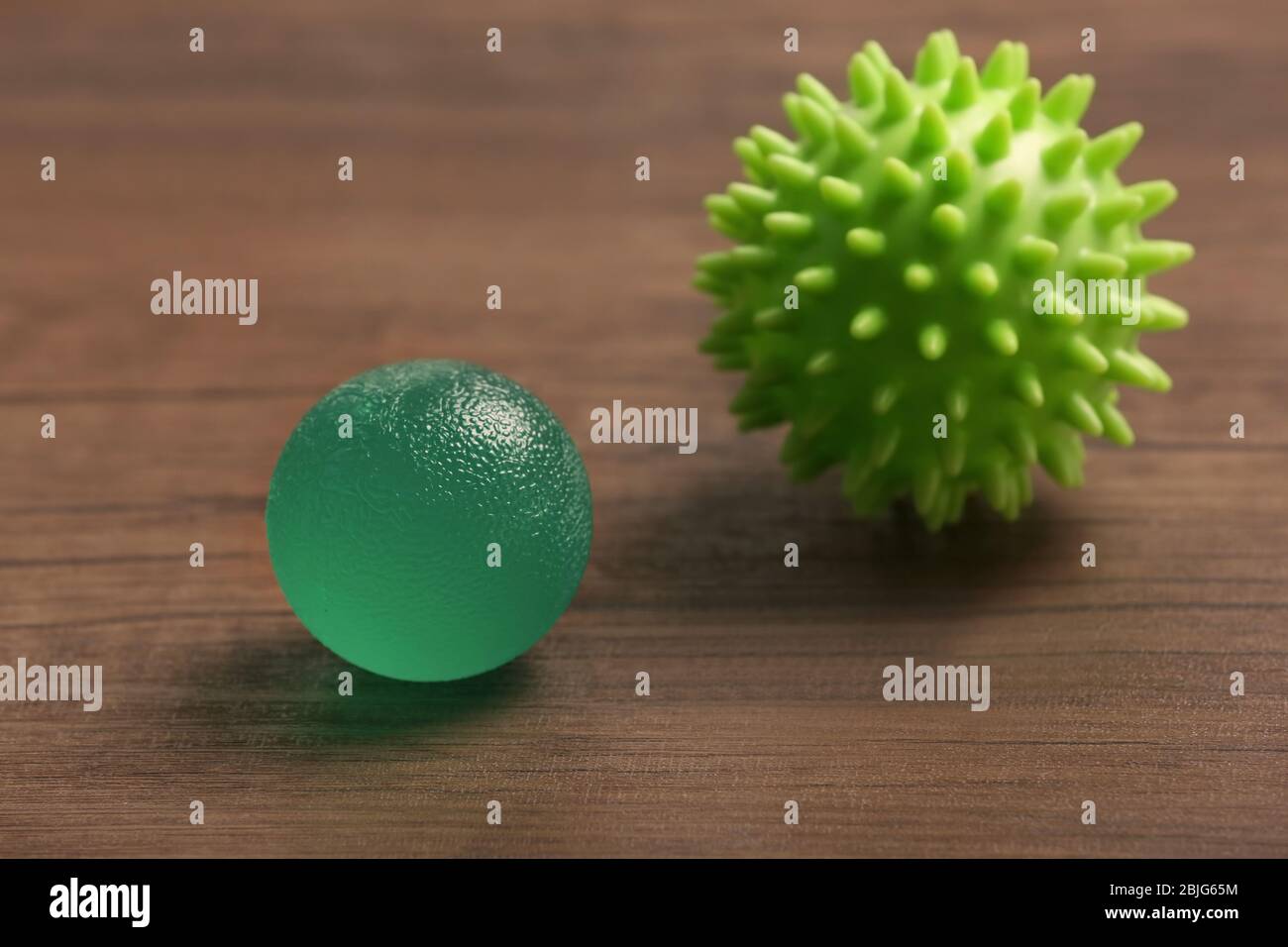 Two rubber balls on wooden background Stock Photo Alamy