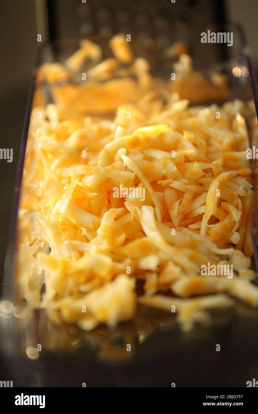 https://c8.alamy.com/comp/2BJG75T/grated-cheese-in-plastic-container-closeup-2BJG75T.jpg