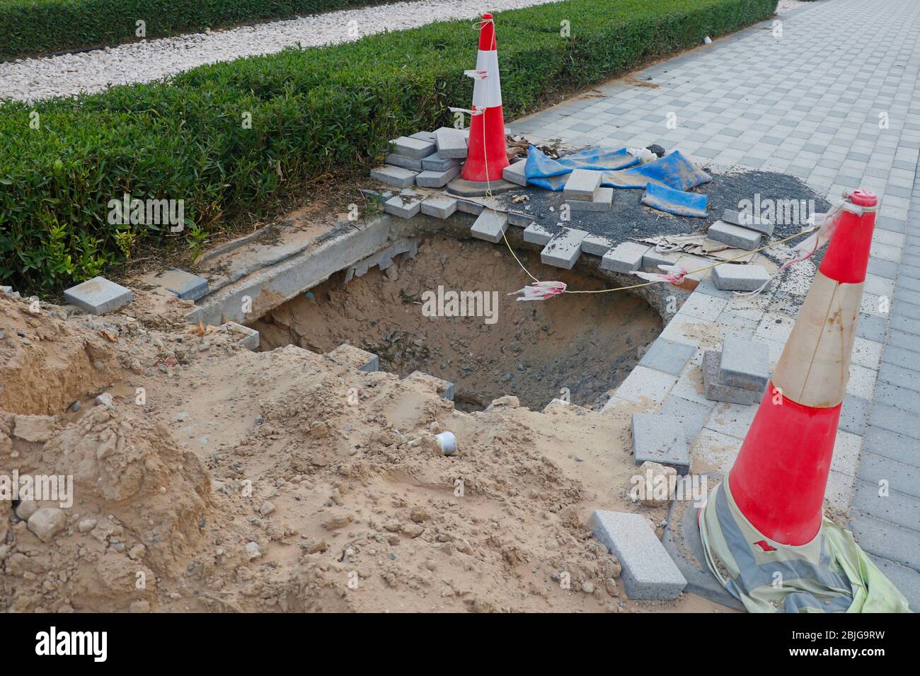 deep excavation with caution posts side of a road Stock Photo - Alamy