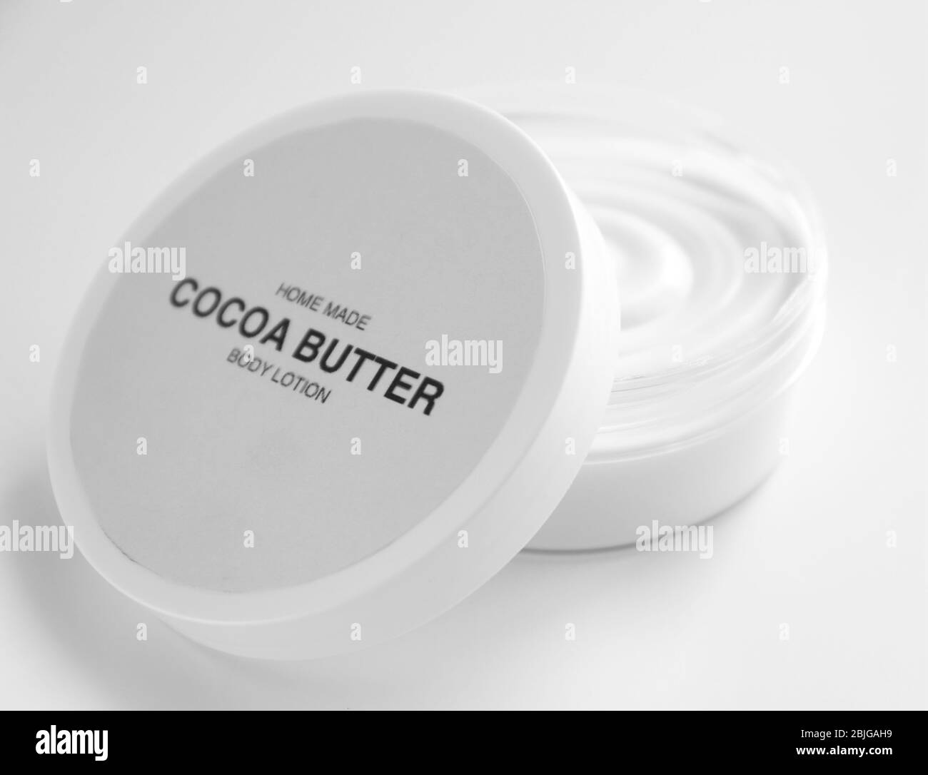 Jar with cocoa butter lotion on white background Stock Photo Alamy