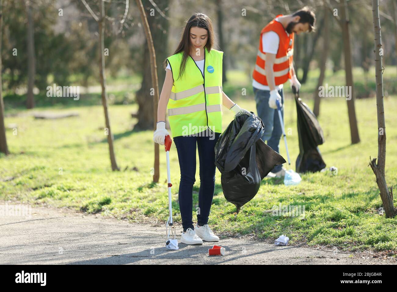 Female picking up litter park hi-res stock photography and images - Alamy
