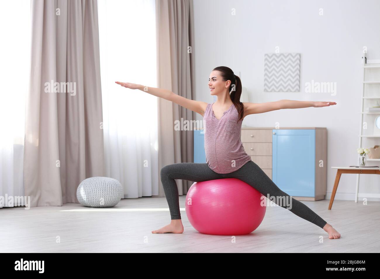 Beautiful pregnant woman doing exercise at home Stock Photo - Alamy