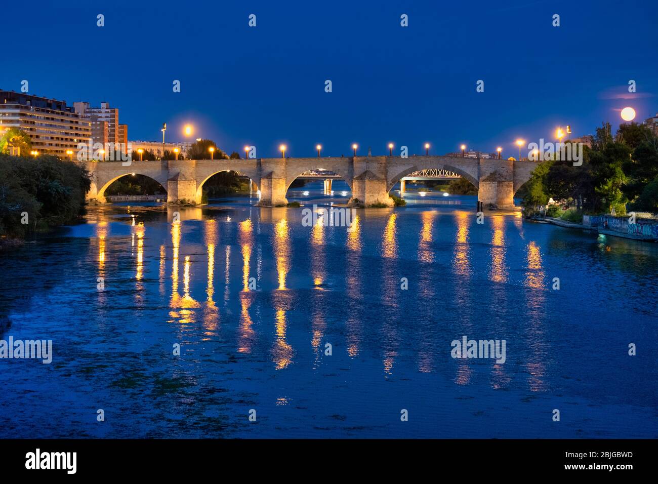 Nighttime view of the Puente de Piedra ancient stone bridge over the river Ebro in Zaragoza, Spain, Europe Stock Photo
