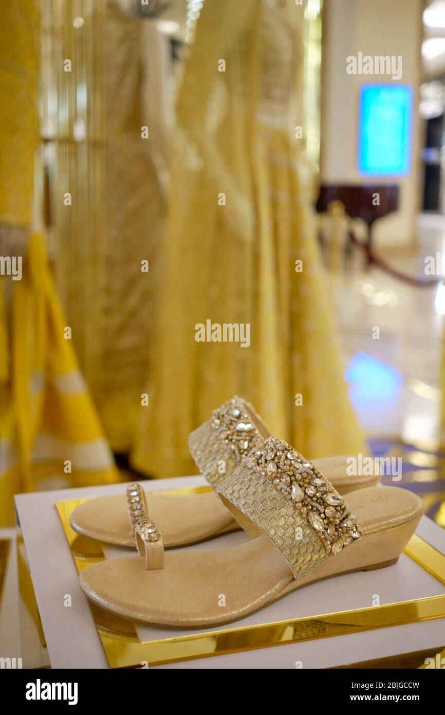 New Delhi / India - October 7, 2019: Jeweled Indian female bridal sandals in a luxury fashion store in New Delhi, India Stock Photo