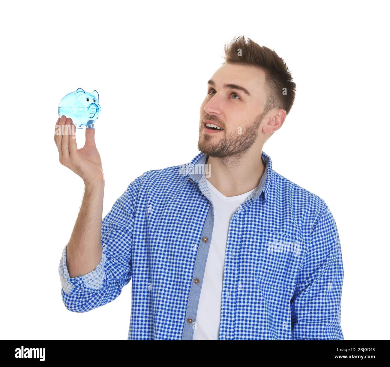 Happy young man holding piggy bank on white background Stock Photo - Alamy