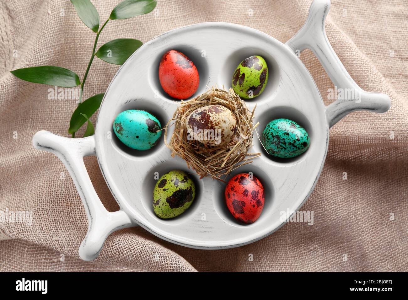 Easter eggs in stand on sackcloth Stock Photo