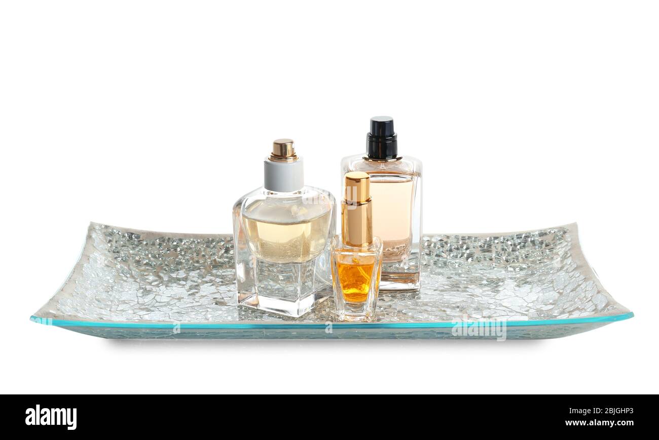 Glass tray with bottles of perfume on white background Stock Photo - Alamy