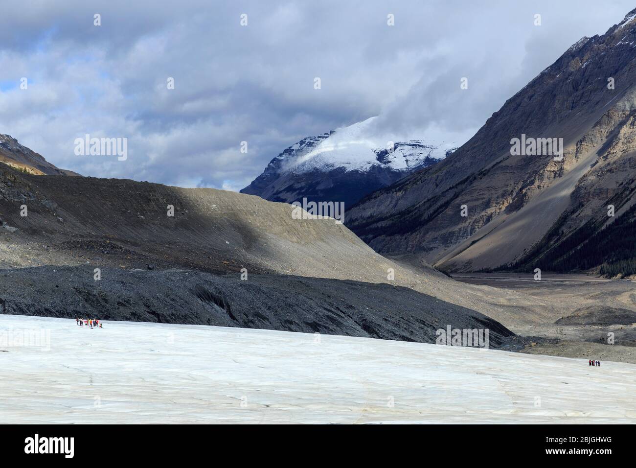 Distant hikers on Athabasca Glacier of Columbia Ice Field in Alberta, Canada Stock Photo