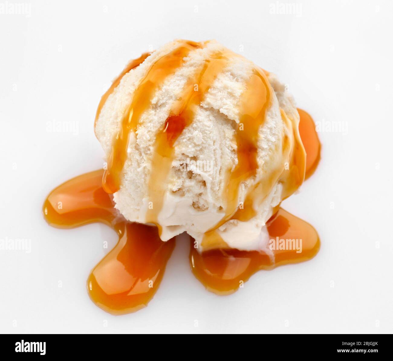 Vanilla ice cream with caramel sauce on white background Stock Photo ...