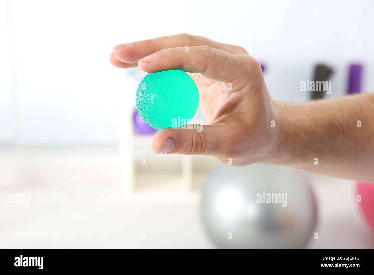 Male hand with stress ball in clinic Stock Photo