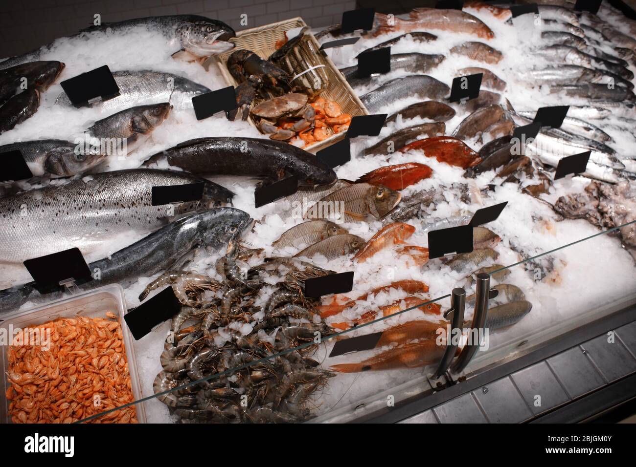 Fresh fish and other seafood in supermarket Stock Photo - Alamy