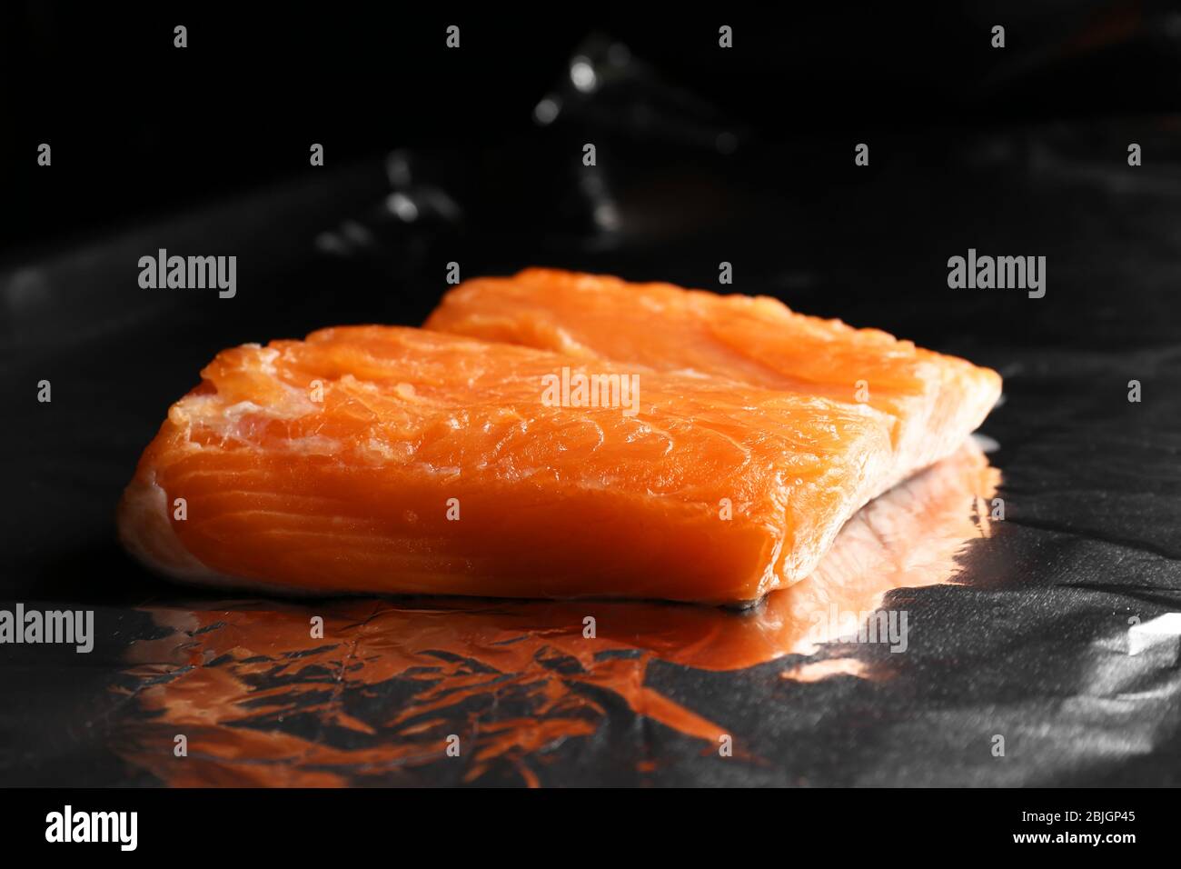 Baking sheet with foil and piece of salmon in oven Stock Photo Alamy