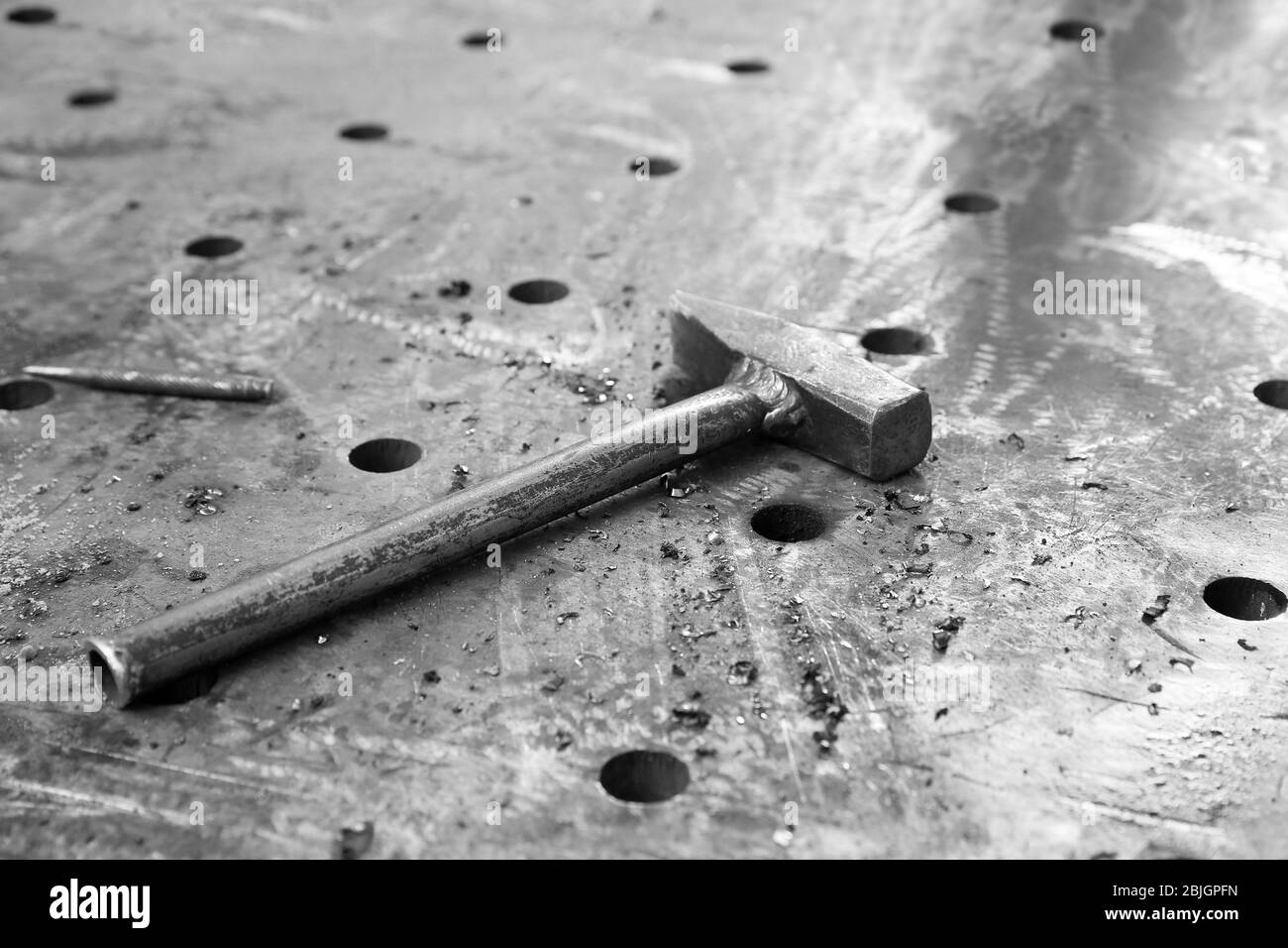 Hammer for metalworking on perforated table in shop Stock Photo Alamy