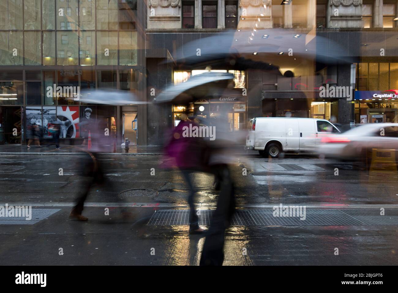 Pedestrians in motion on a moody, rainly day in lower Manhattan, New York City Stock Photo