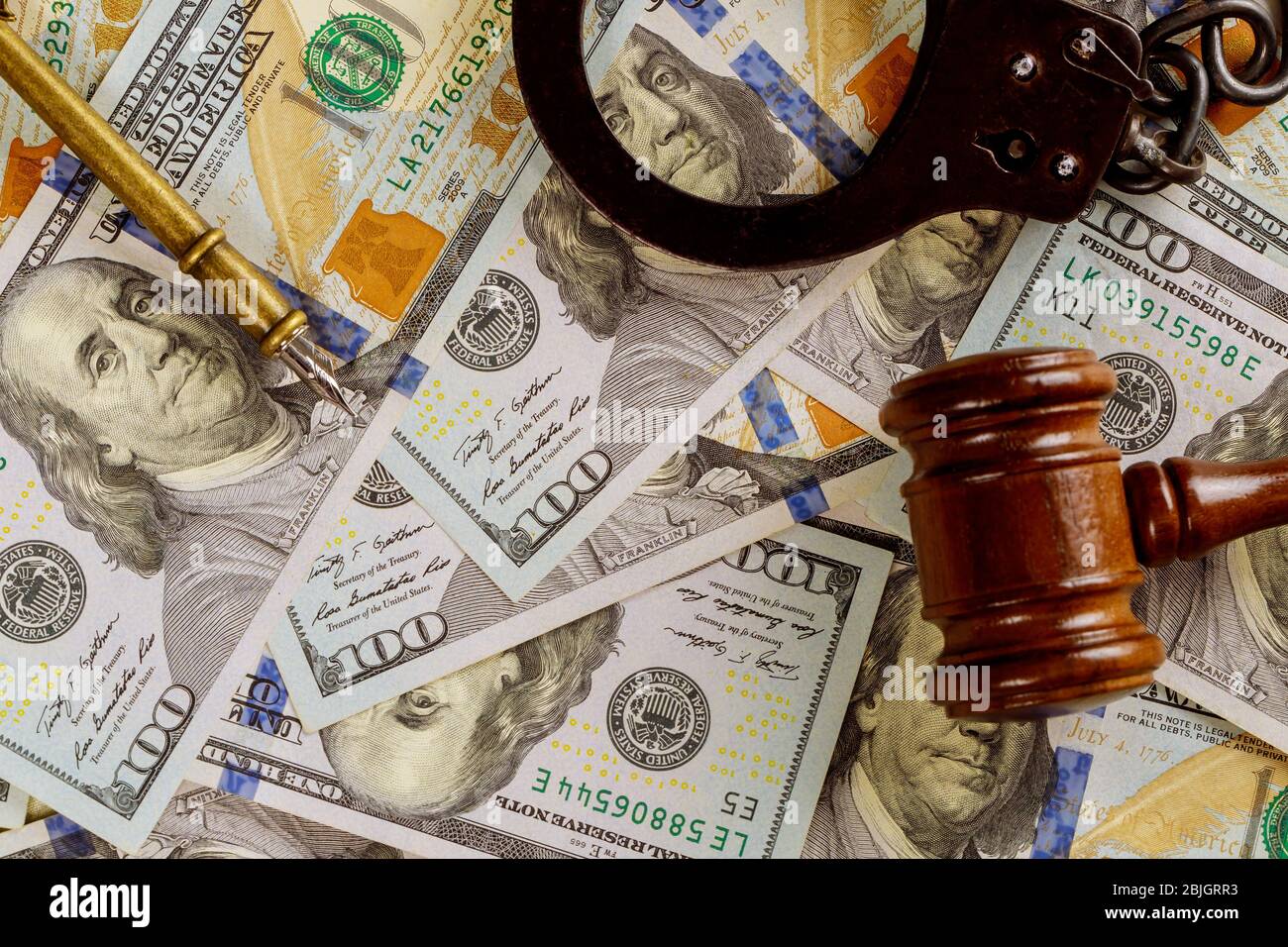 Justice and law concept cash dollars in banknotes judge gavel with handcuffs in court Stock Photo