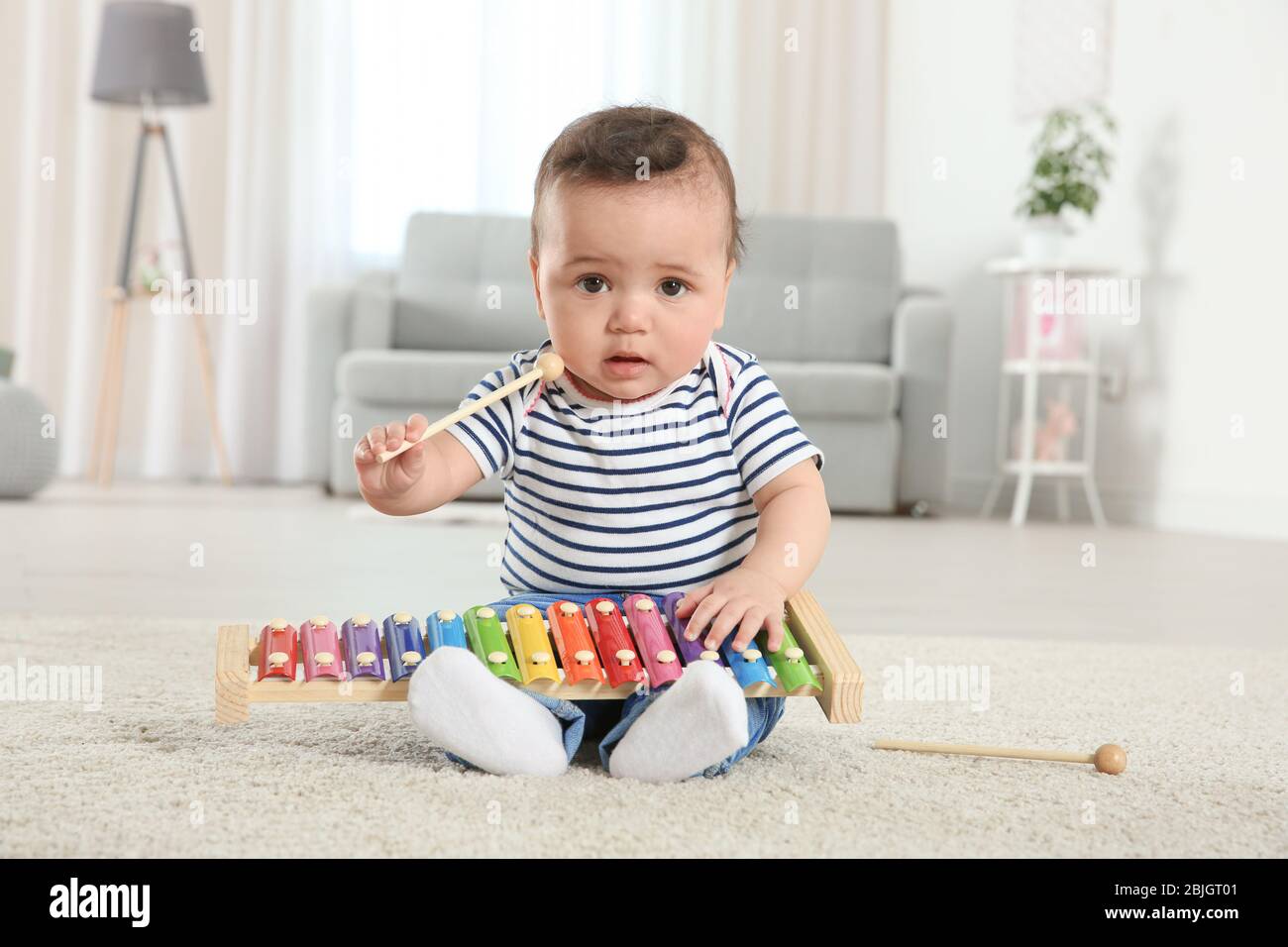 Cute little baby with xylophone at home Stock Photo Alamy
