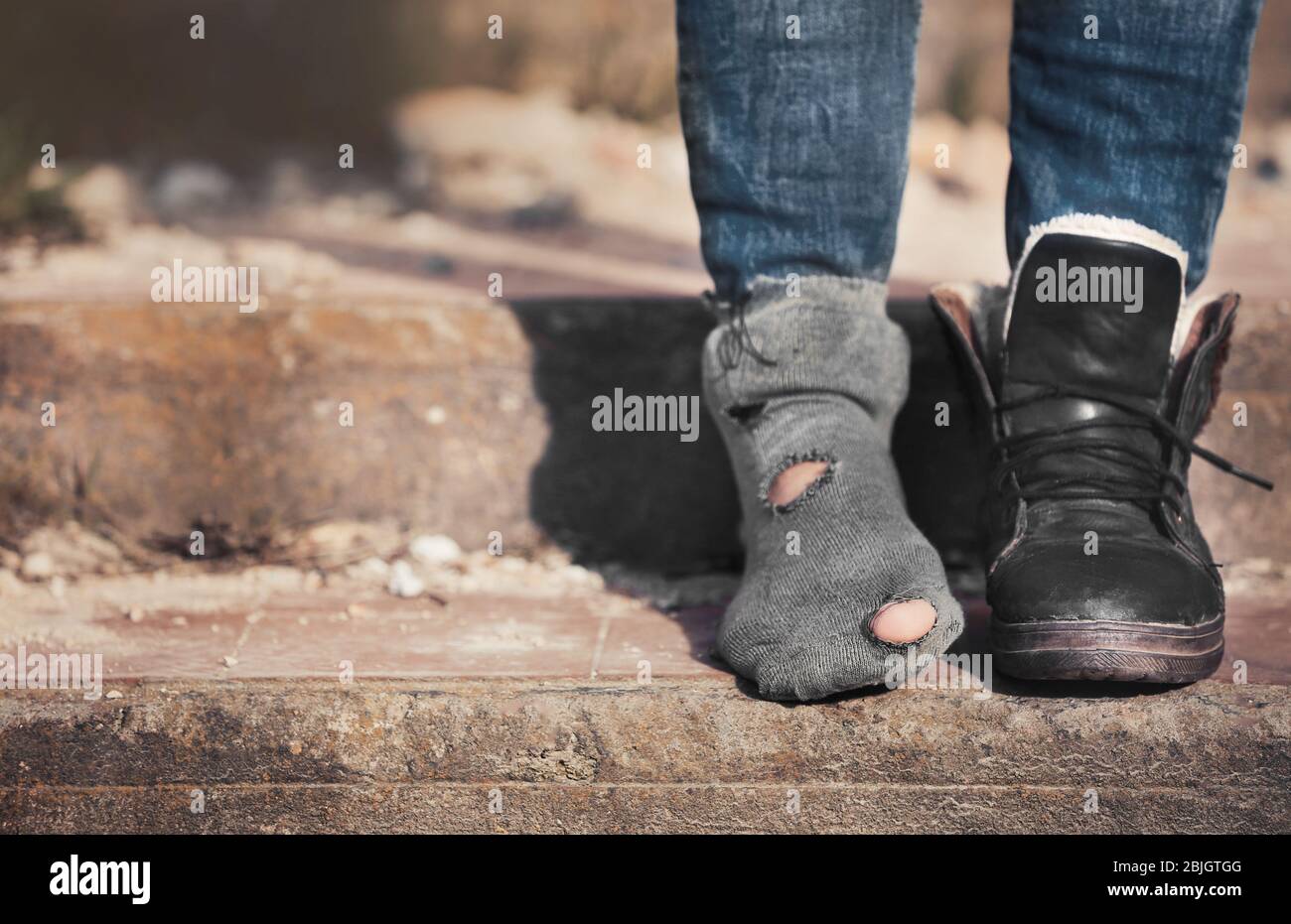 Poor woman wearing old dirty clothes Stock Photo Alamy