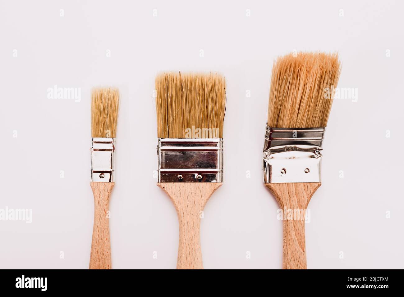 Three new painter brushes of various sizes isolated on white background
