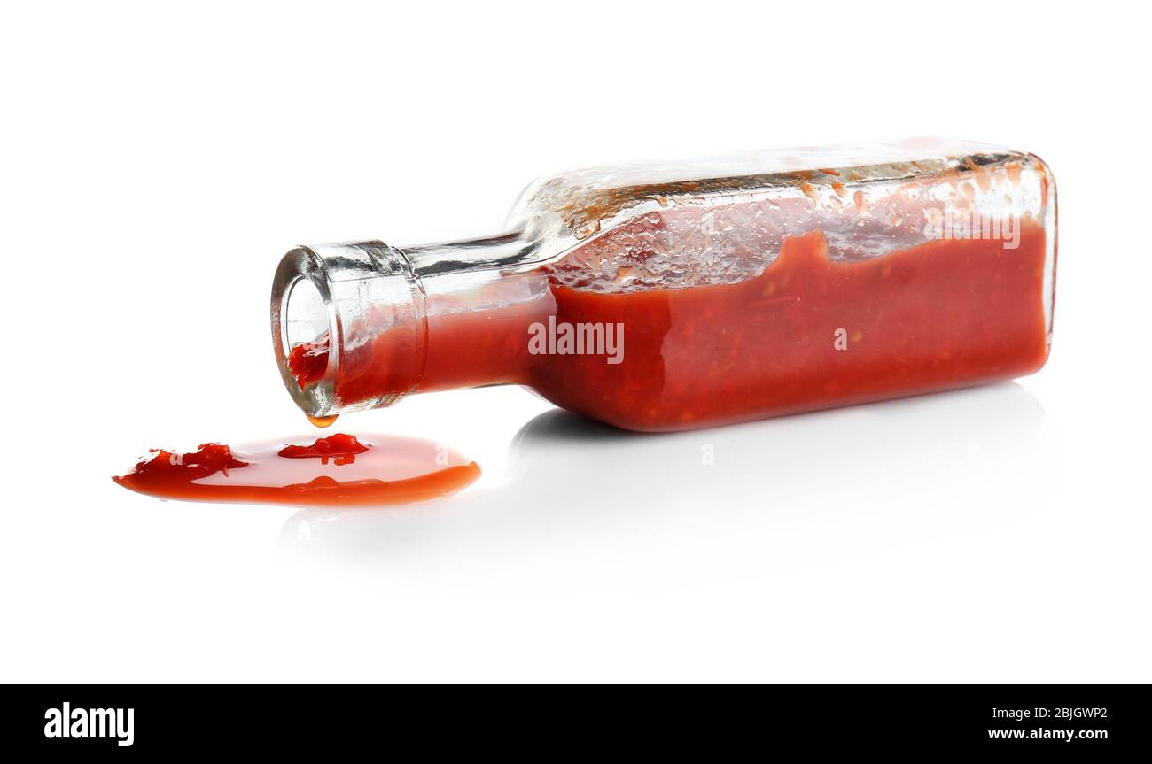 Glass bottle with spilled tomato sauce on white background Stock Photo ...