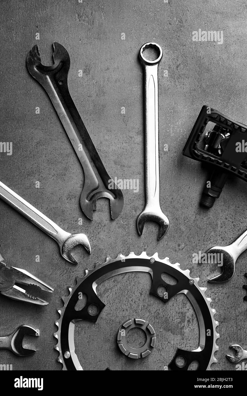 Bicycle parts and repair tools on gray background Stock Photo Alamy