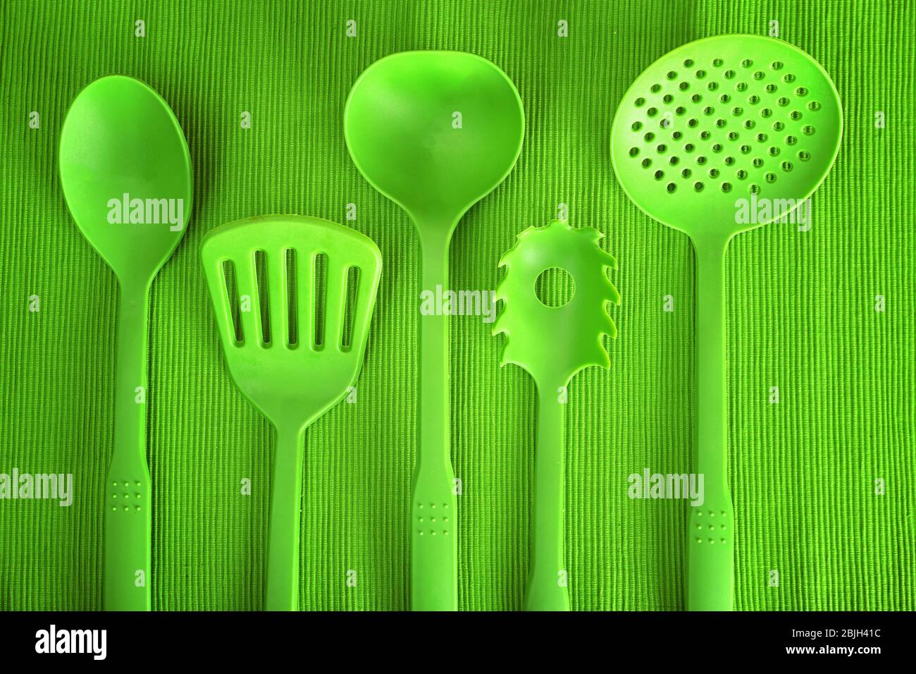 Green utensils on textured background Stock Photo Alamy