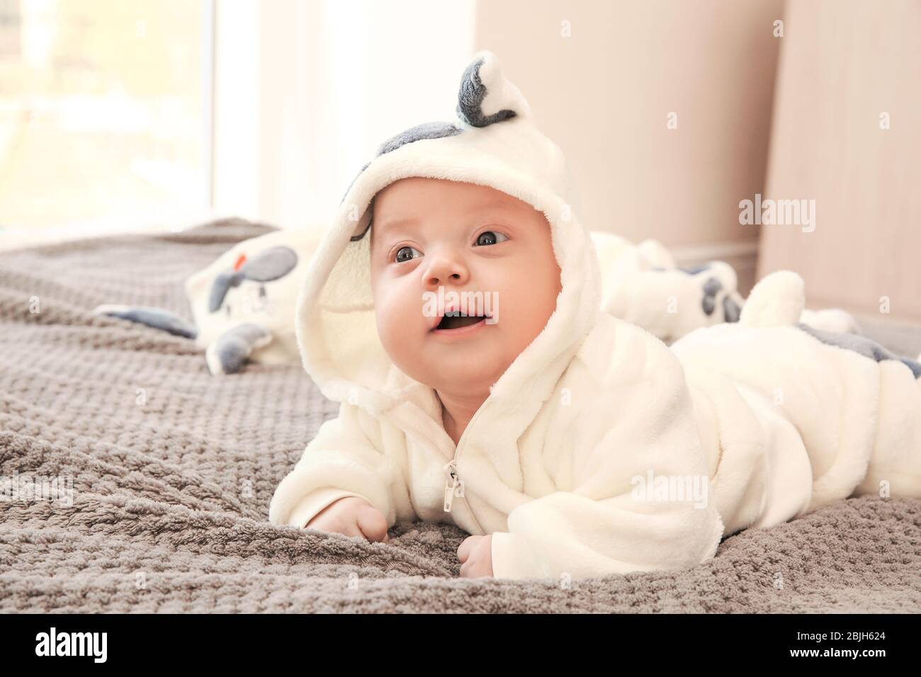 Cute little baby lying on bed at home Stock Photo - Alamy
