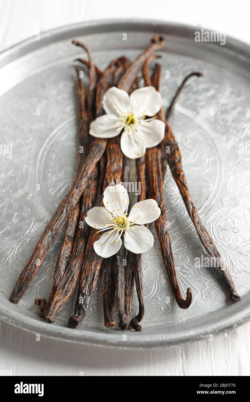 Holy wood sticks with dried flowers bouquet for meditation and spiritual  practices, wooden tray with palo santo sticks on white marble table  background, Stock image