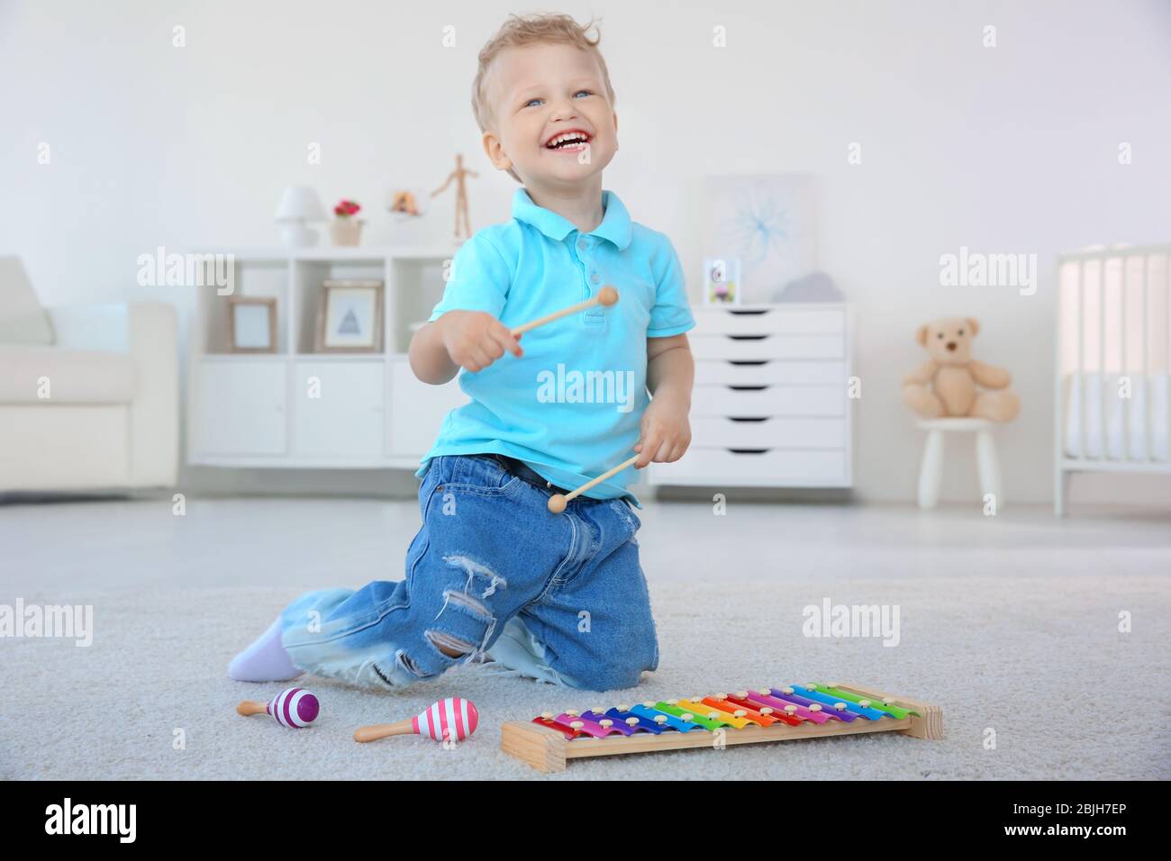Cute little boy with xylophone at home Stock Photo Alamy