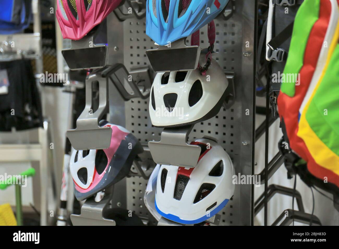 Stand with helmets in bicycle shop Stock Photo Alamy