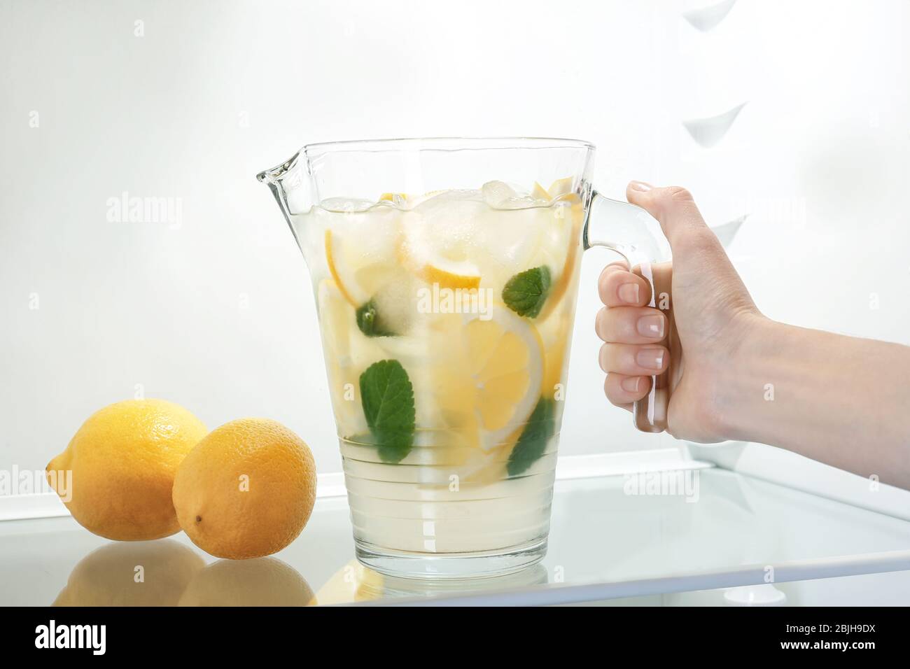 Female hand taking jug of lemonade from fridge Stock Photo Alamy