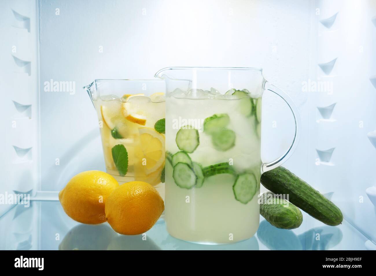 Jugs with lemonade in fridge Stock Photo