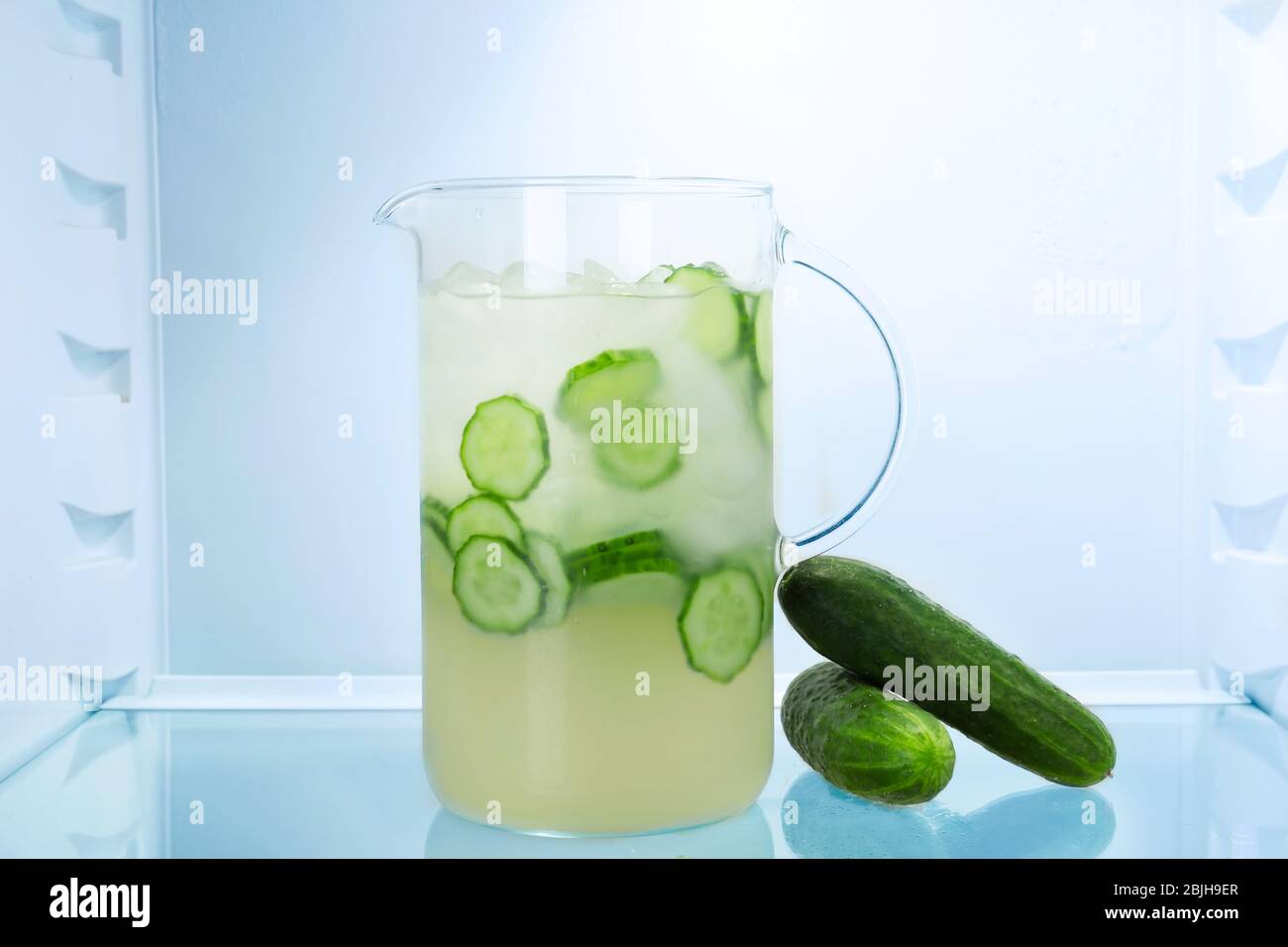 Jug of fresh cucumber lemonade in fridge Stock Photo