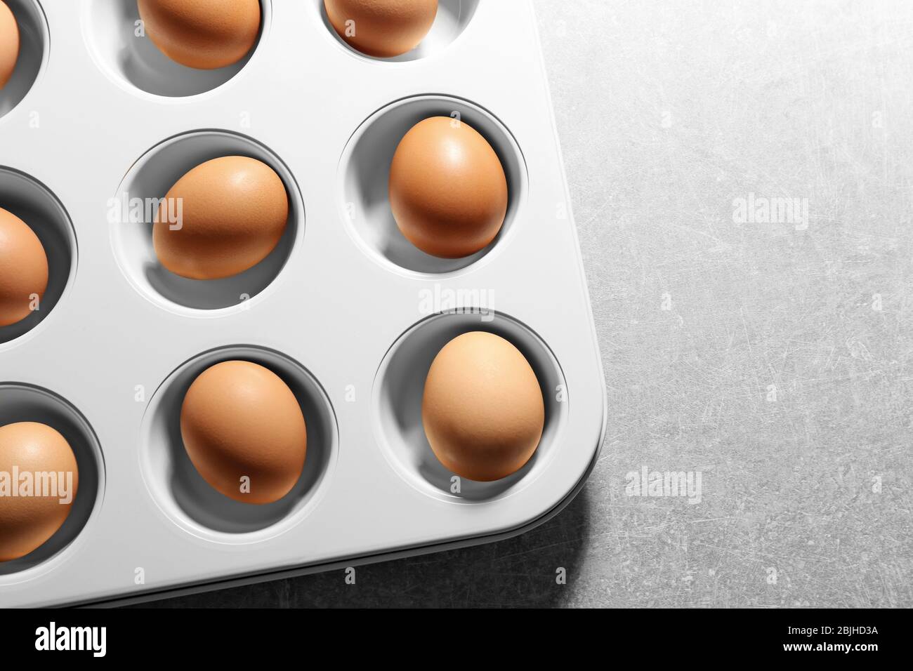 Muffin tin with hard boiled eggs on table Stock Photo - Alamy