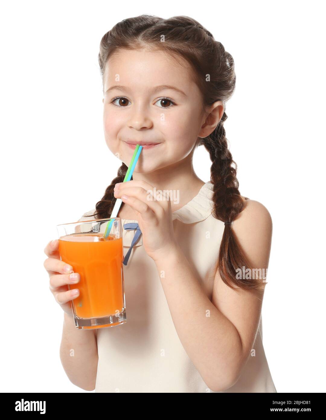 Cute little girl drinking juice on white background Stock Photo - Alamy