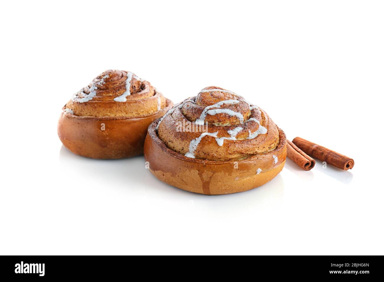 Sweet cinnamon rolls and sticks on white background Stock Photo - Alamy
