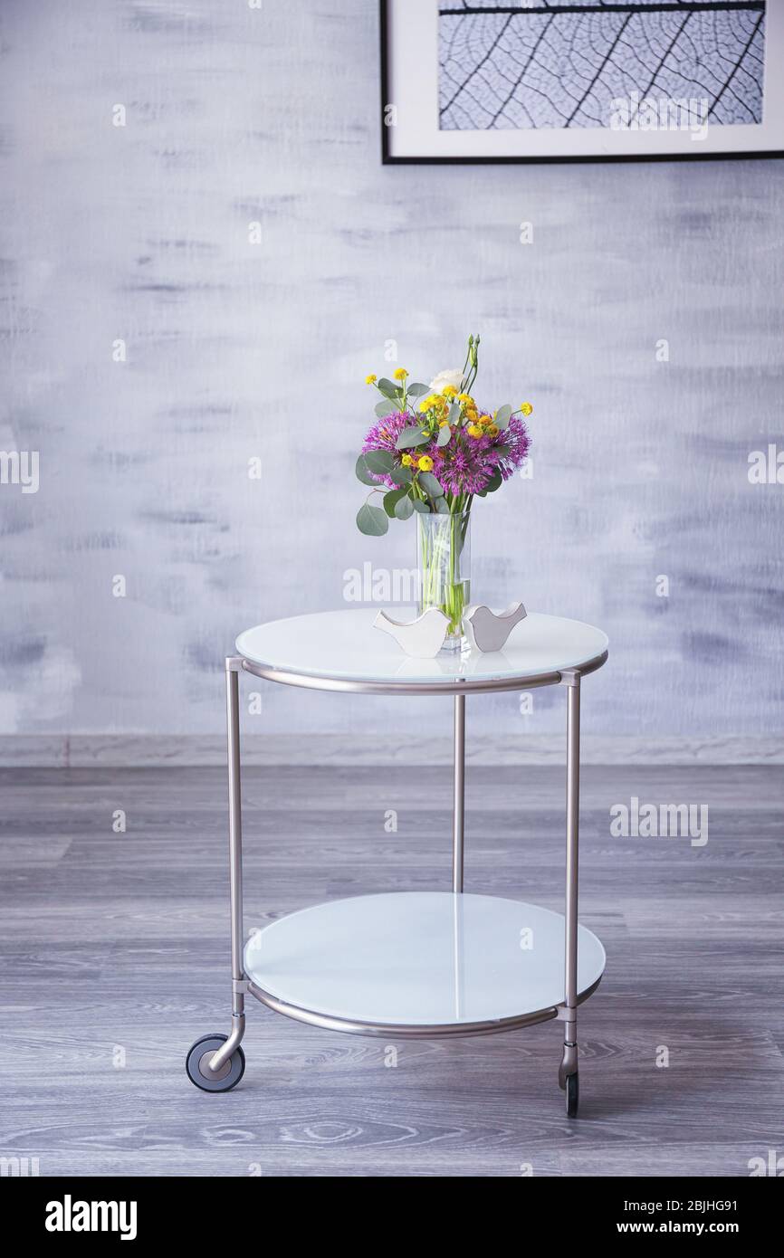 Beautiful flower bouquet on coffee table in room Stock Photo - Alamy