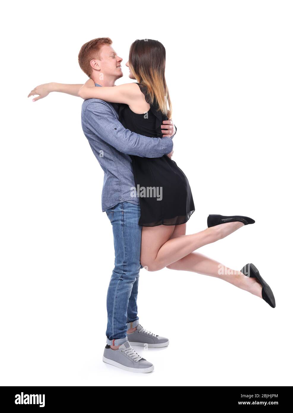Happy young couple on white background Stock Photo - Alamy