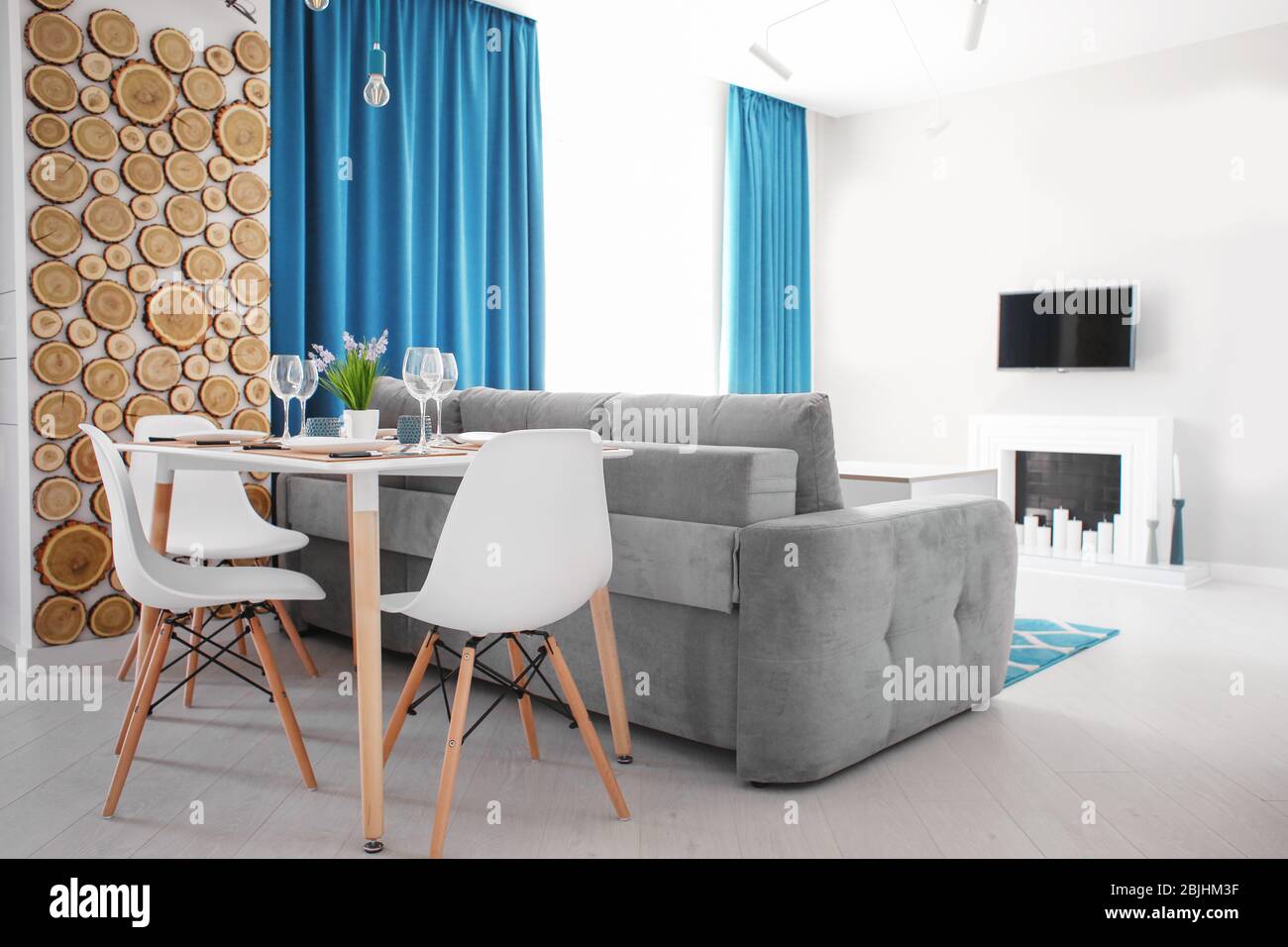 Interior of light modern dining room with served table Stock Photo - Alamy