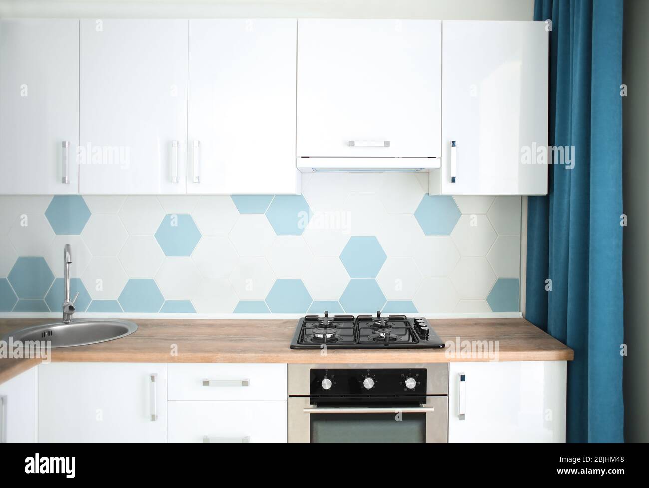 Interior of light modern kitchen with stove Stock Photo - Alamy
