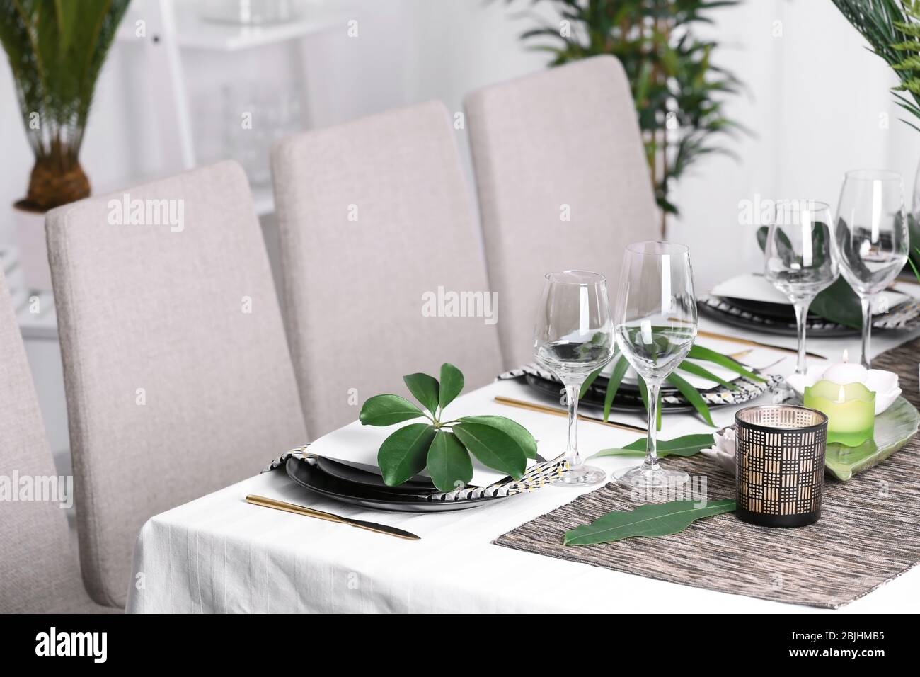 Beautiful table setting with green tropical leaves Stock Photo