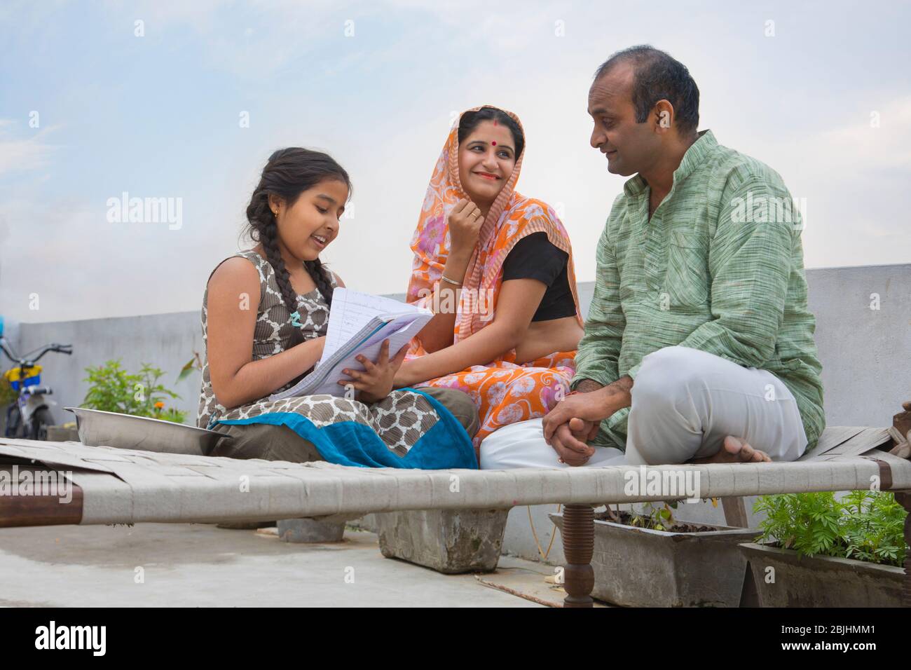Indian mother and father helping daughters with homework Stock Photo ...