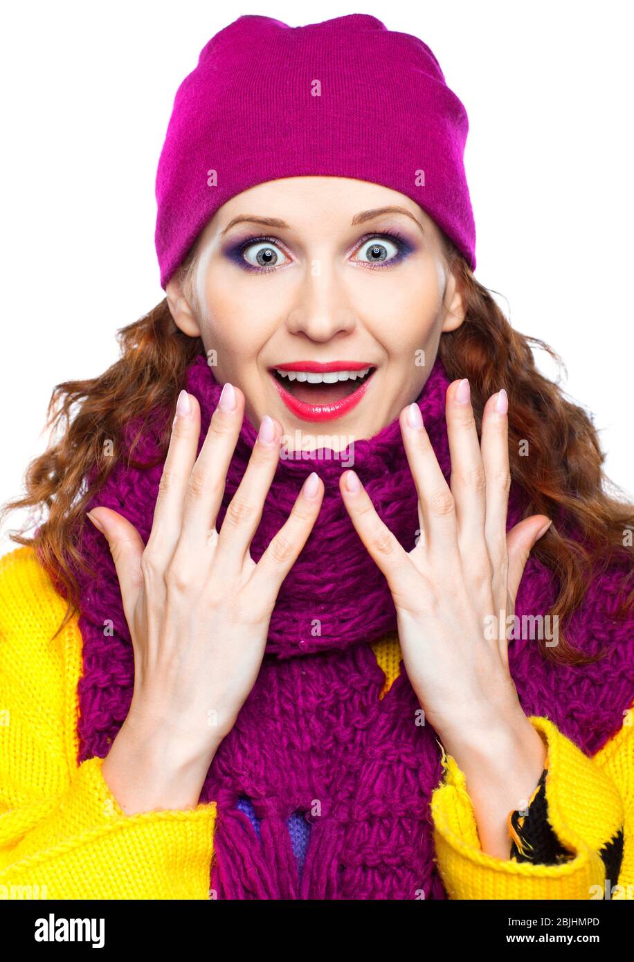 Shocked Young woman in hat and scarf isolated on white background Stock Photo
