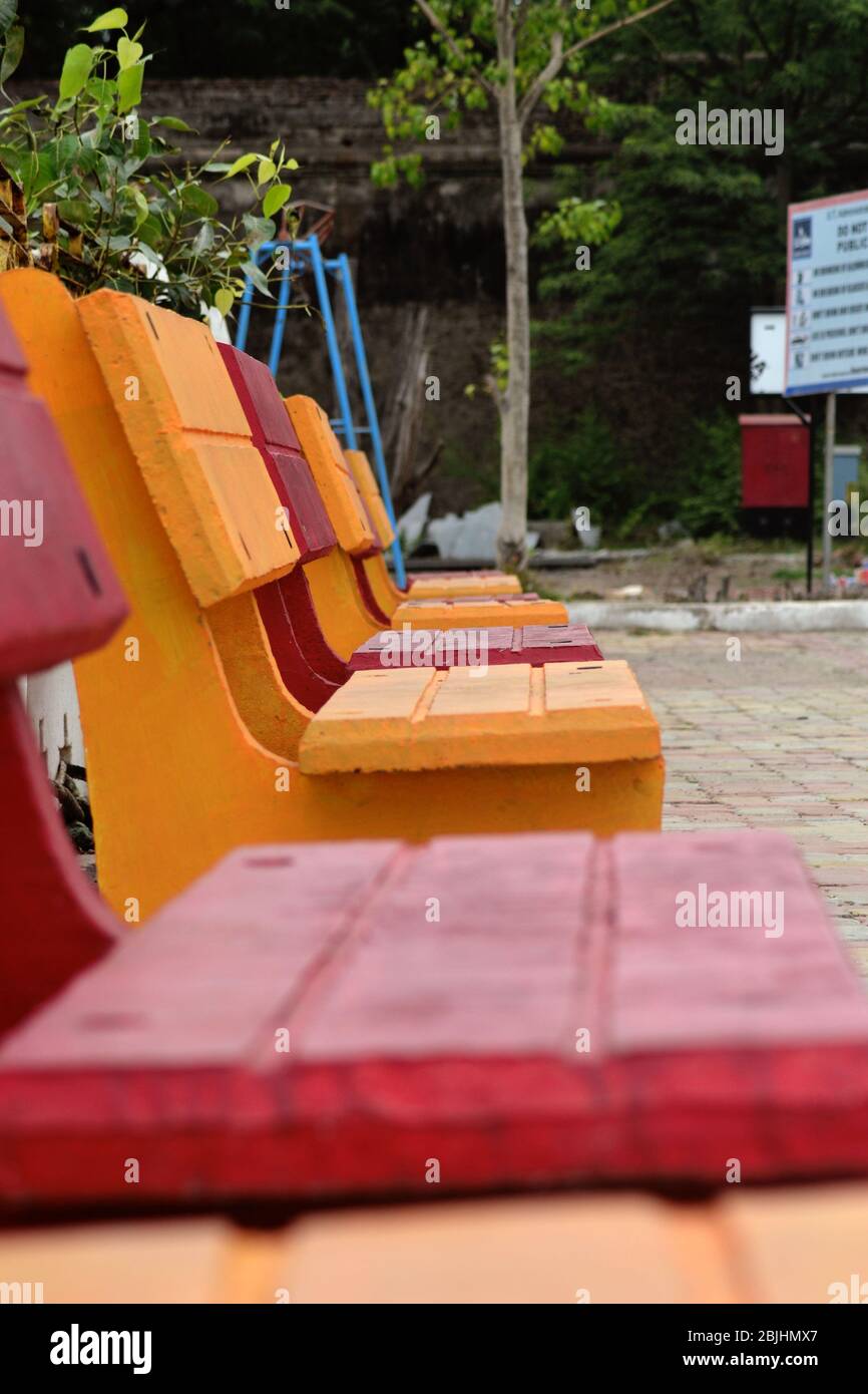 There are outdoor lounge chair backrest shelf aluminum pedestal base wood benches garden chairs courtyard garden. Stock Photo