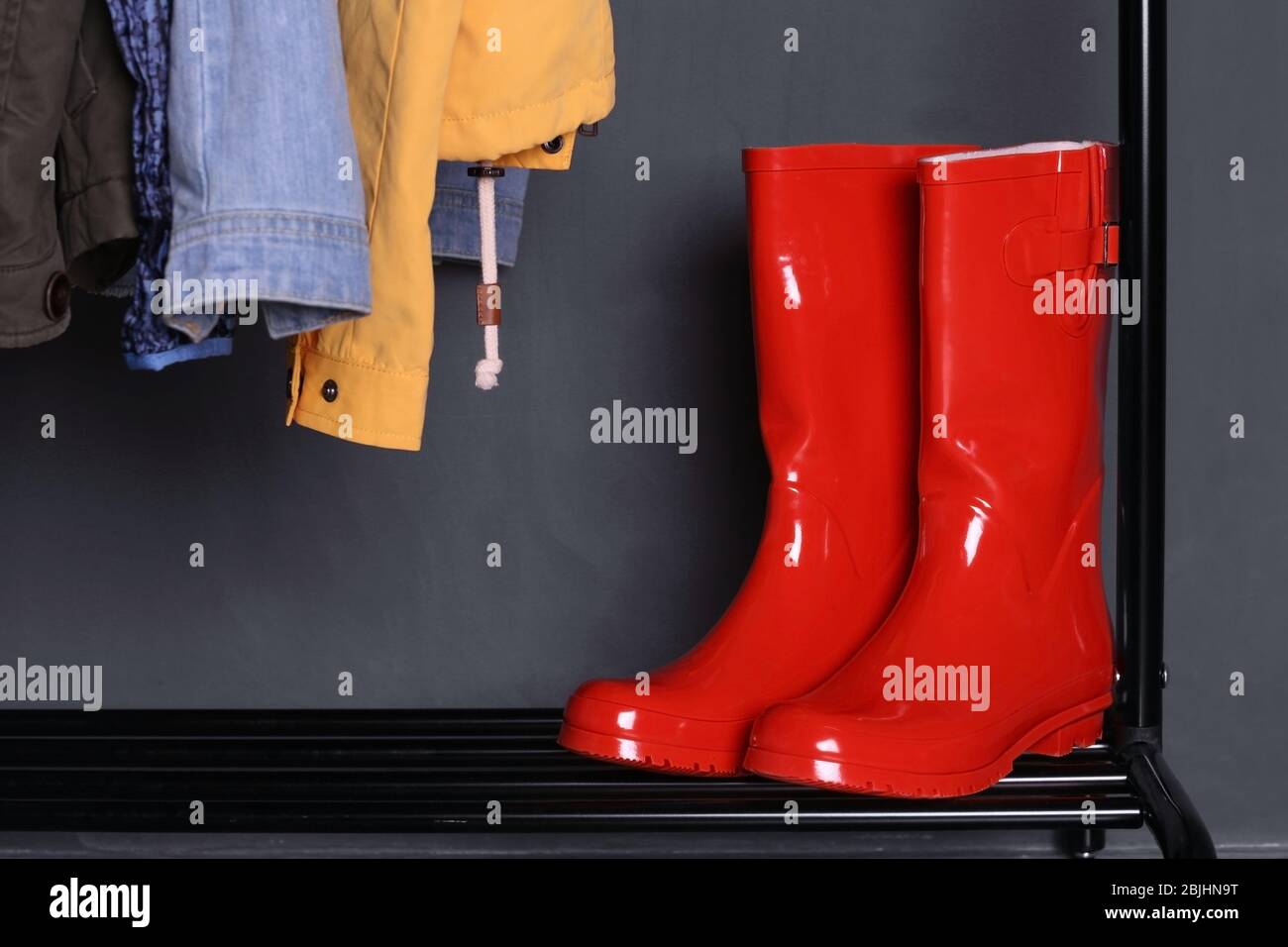 Red wellington boots on shelf near wall Stock Photo - Alamy