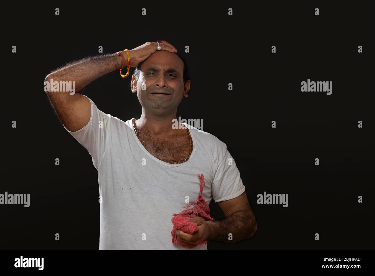 Depressed Indian farmer standing and holding his head in disbelief ...