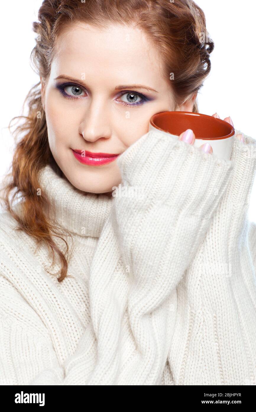 Beautiful girl in a cashmere sweater with cup of hot chocolate or coffee or tea Stock Photo