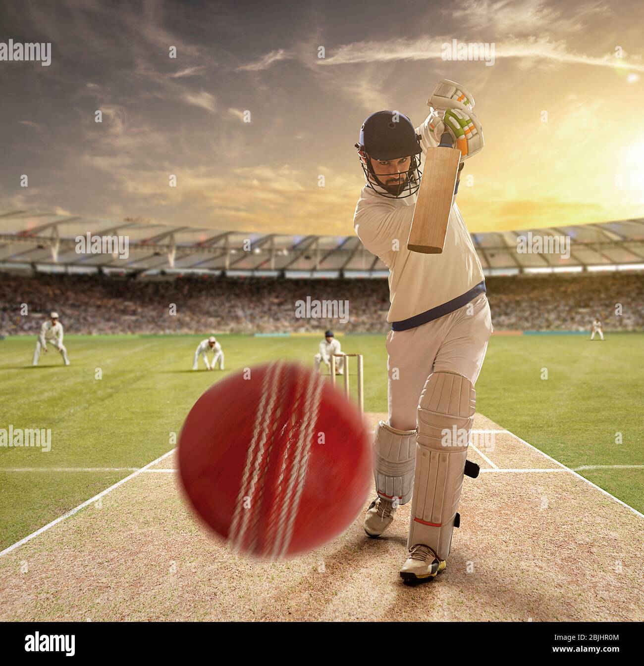 A young sportsman playing cricket with stance of hitting the ball Stock