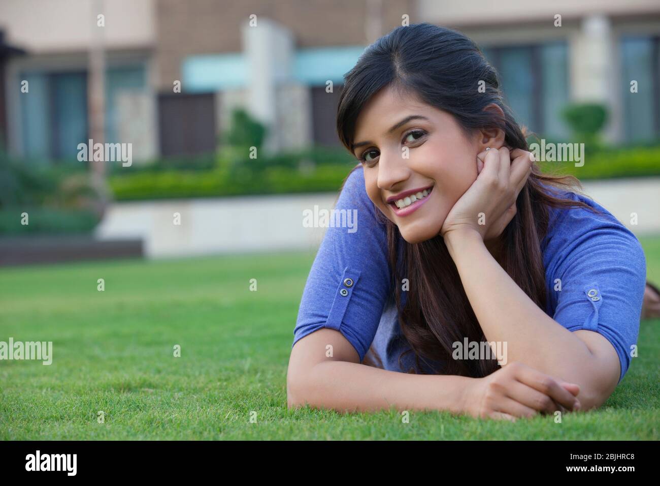 Portrait of a woman lying on a lawn Stock Photo