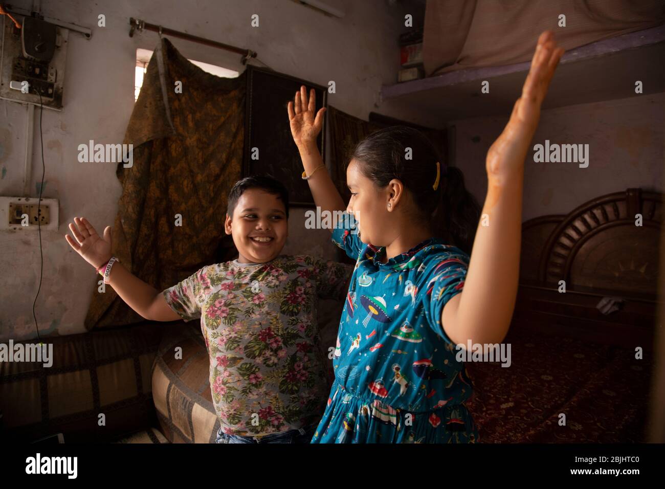 young brother and sister dancing at home Stock Photo